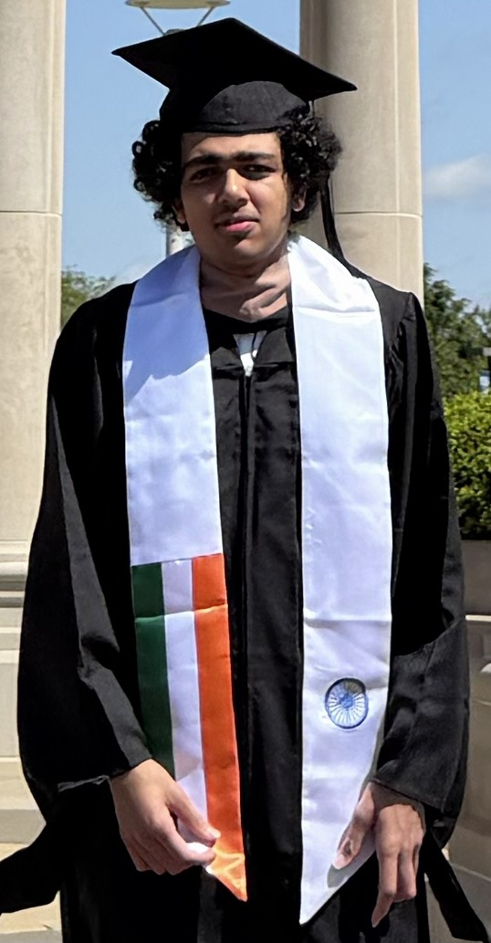 Mit Pandya at graduation, wearing a cap and gown